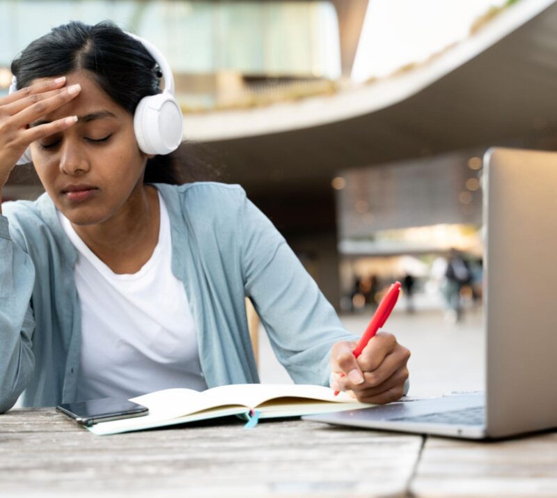 Tired Indian student studying, exam preparation. Asian freelancer hard working, missed deadline